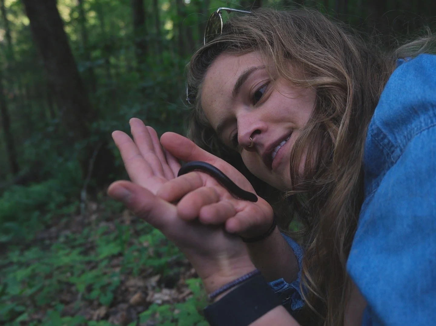A girl admiring a millipede in her hand