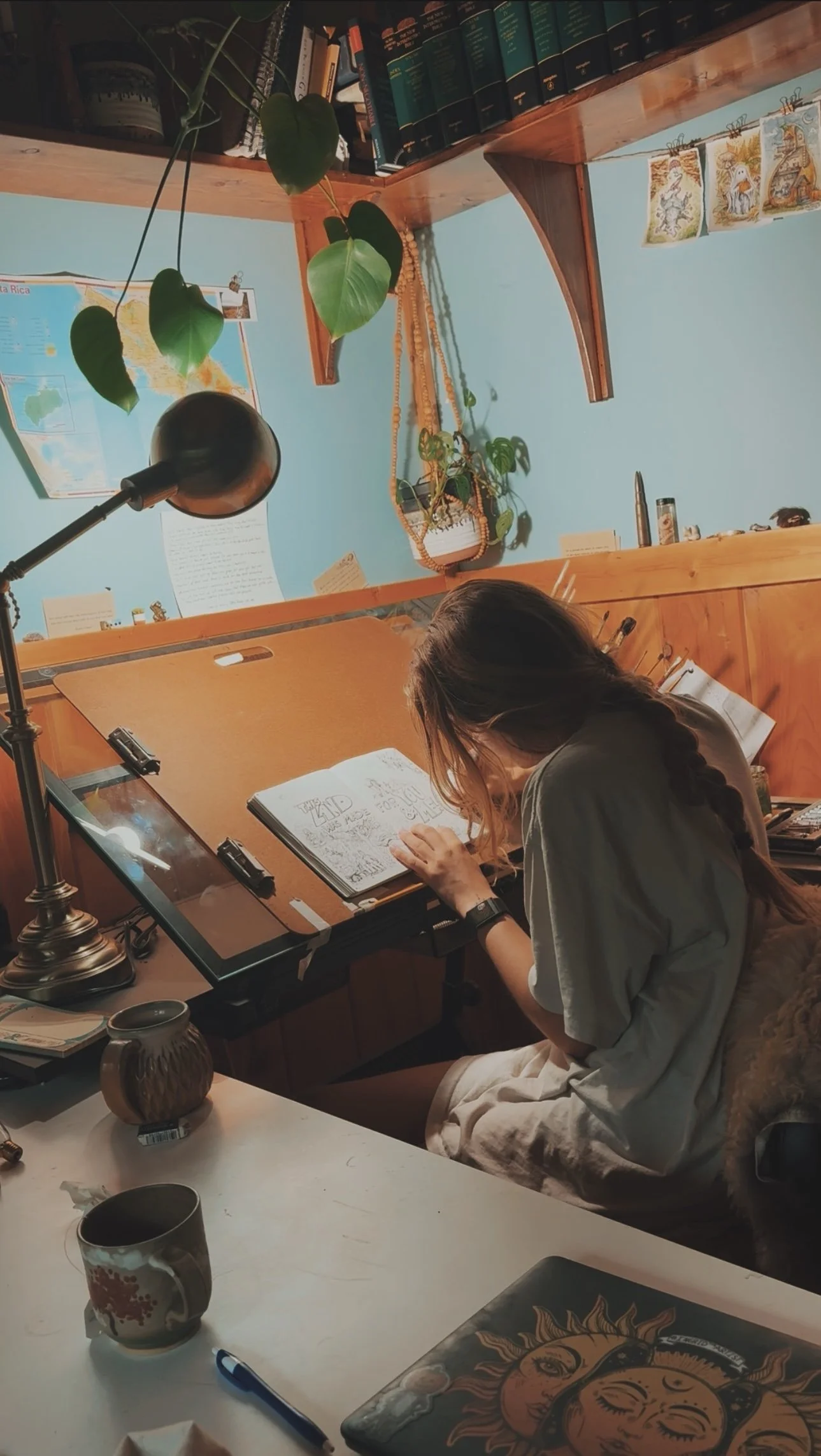 Woman artist working at a drafting table