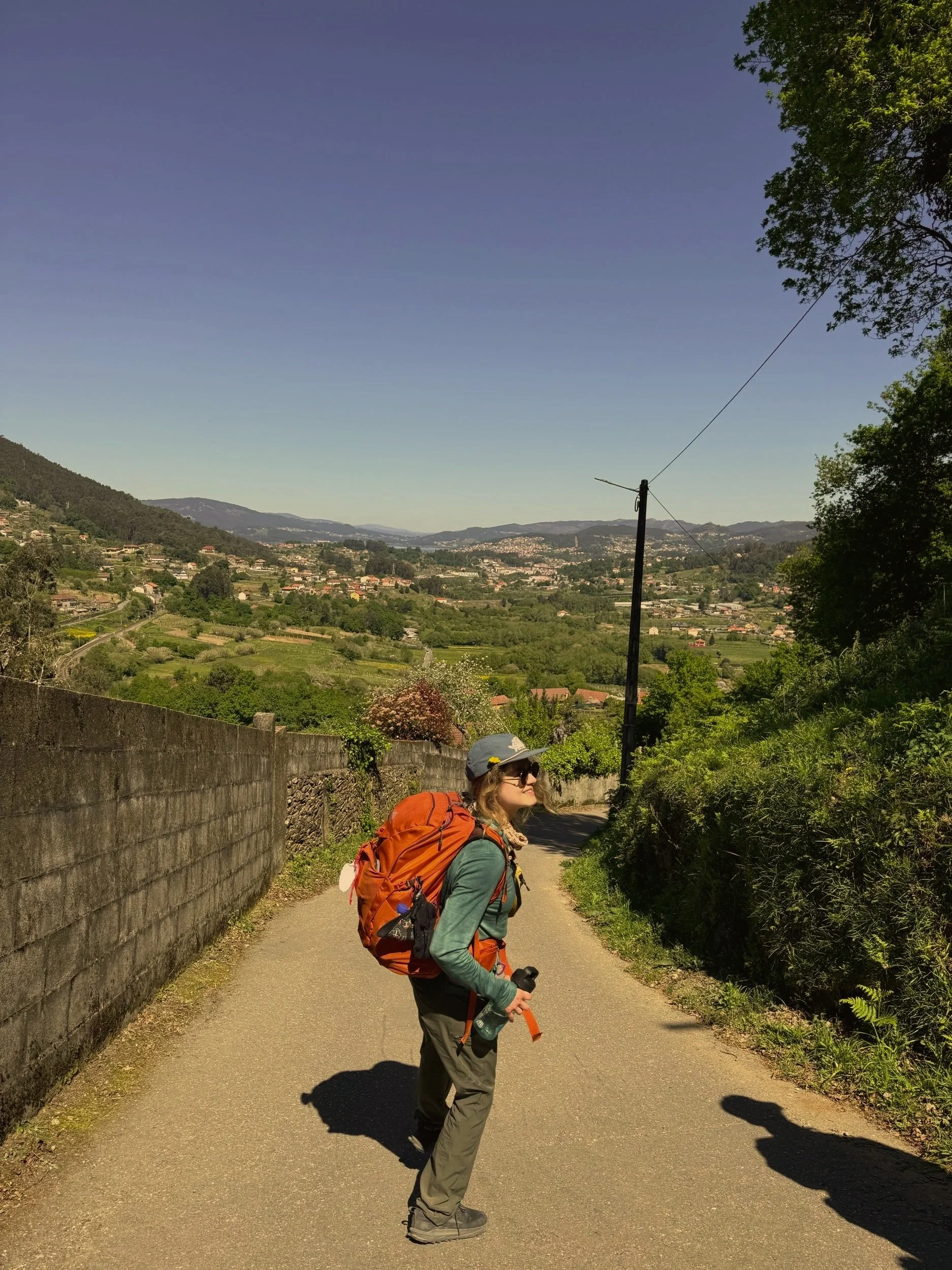 A backpacker overlooking a mountainous villiage