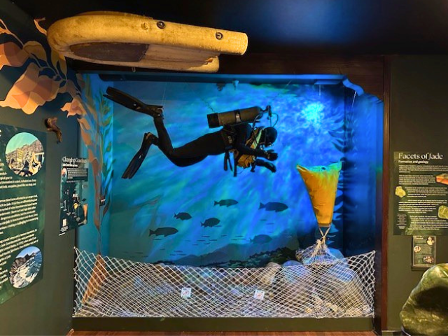 A sculpture combining bronze and jade in a grail shape with a hole in the middle