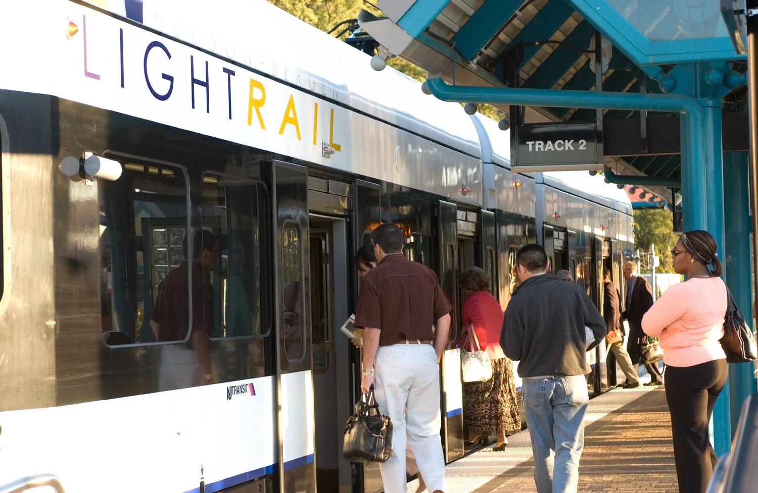 People boarding New Jersey Transit light rail car
