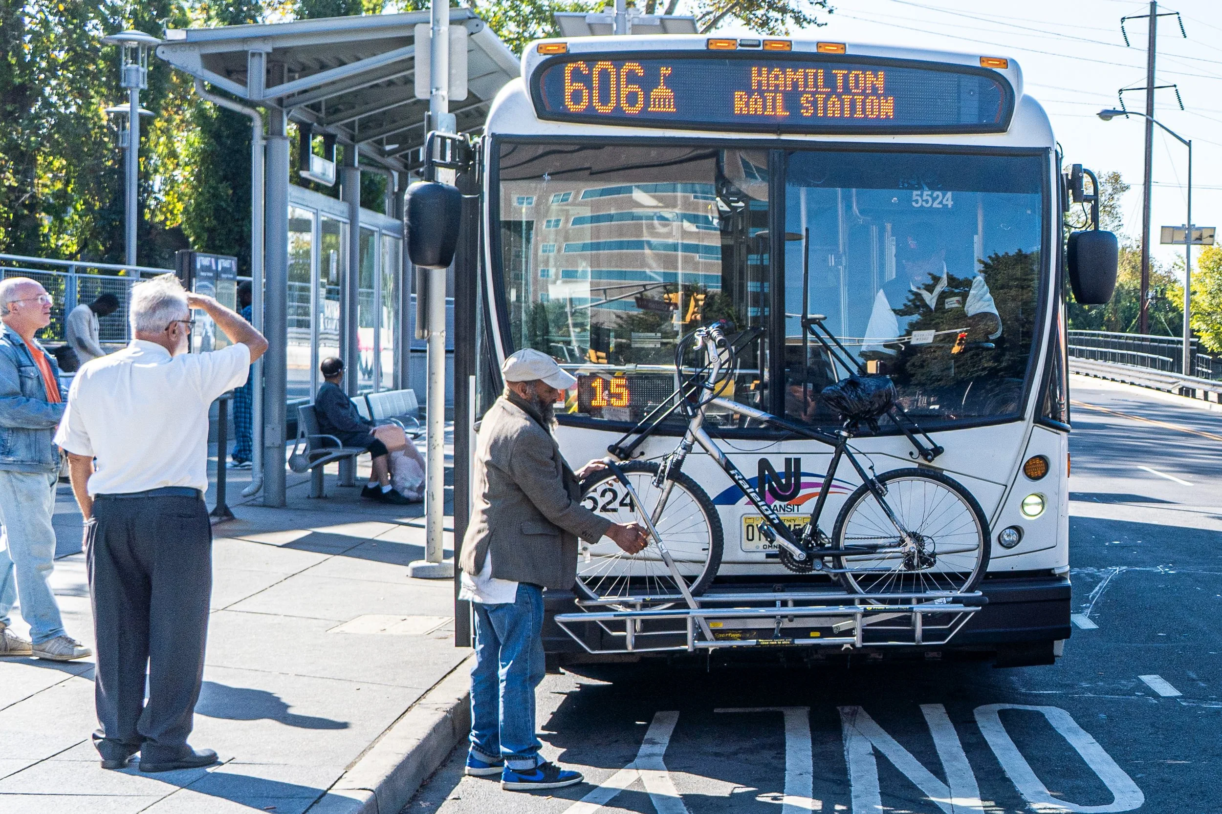 A person securing their bicycle to a New Jersey transit bus