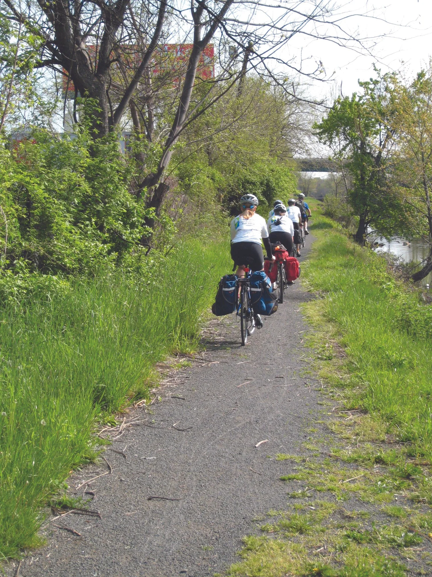 Bike riders on path along river