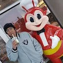 CryptoGain Google Play Store reviewer Luis Domingo profile photo with person and Jollibee mascot character