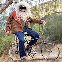 CryptoGain Google Play Store reviewer Greg Opperman profile avatar showing photograph of bearded person on bicycle
