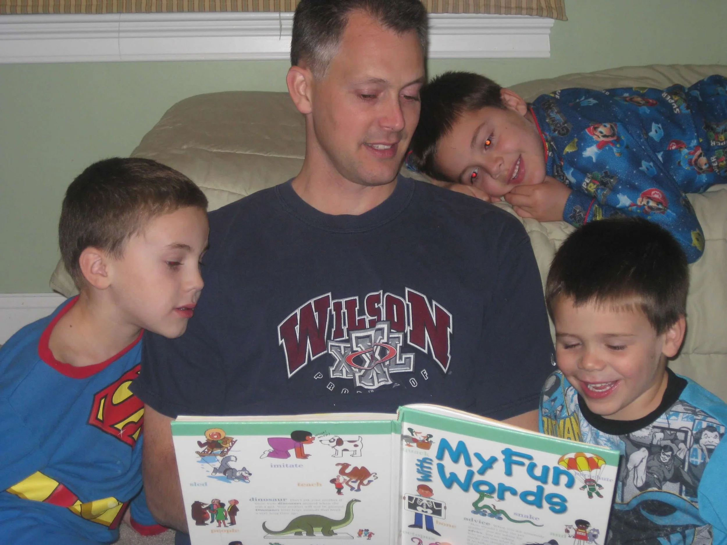 An older picture of my husband reading with my sons
