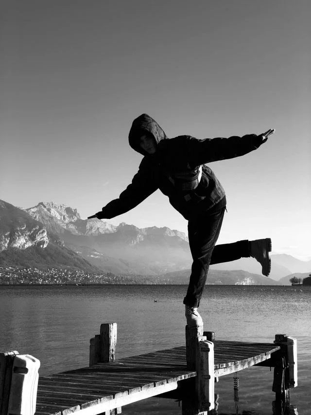 Someone balancing on a dock post