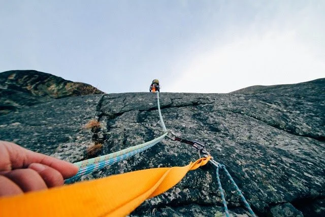 Rock climbing holding on to a rope