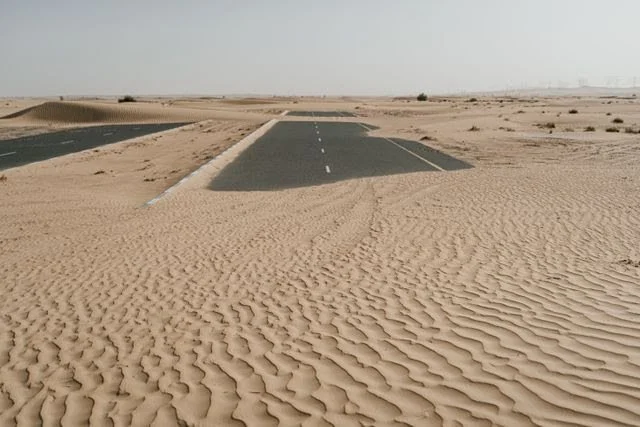 Sand blowing over a road