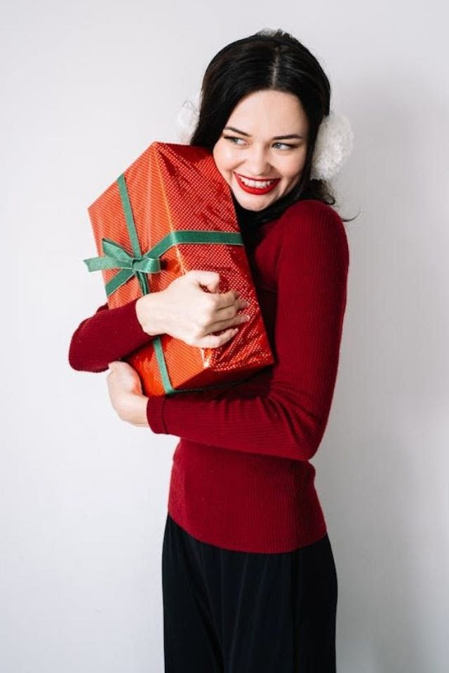 Woman hugging a present with a smile