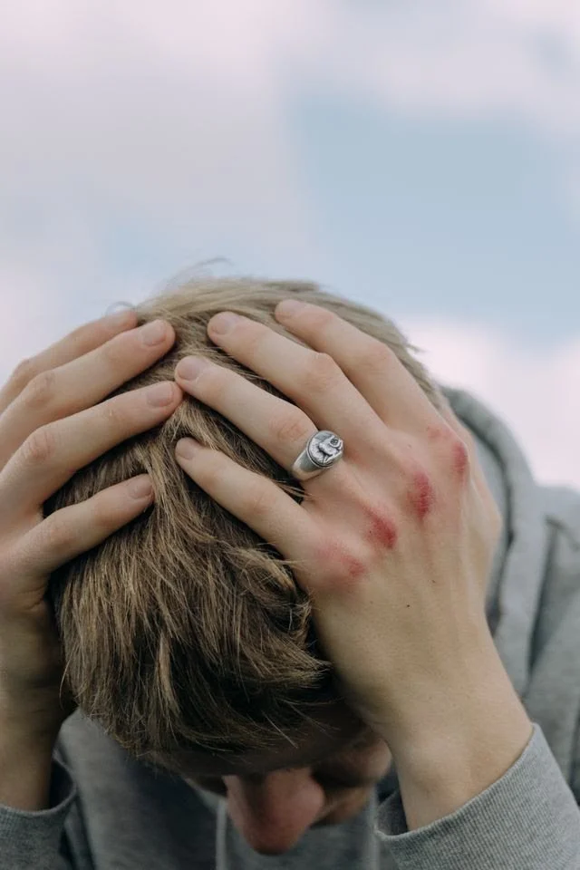 Man clutching his head