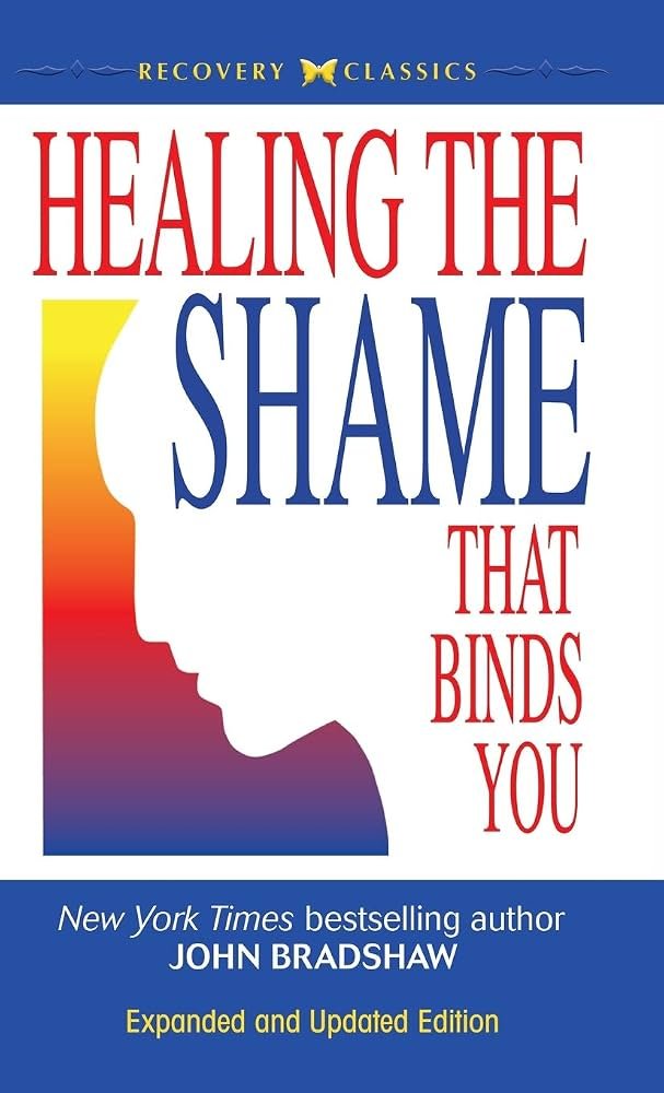 Book cover titled 'Healing the Shame That Binds You' by John Bradshaw, with a silhouette of a person's profile in rainbow colors, and a blue bottom section with additional text.