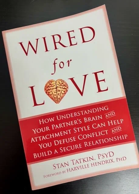 Book titled 'Wired for Love' by Stan Tatkin, PSYD, with a subtitle about understanding your partner's brain and attachment style.