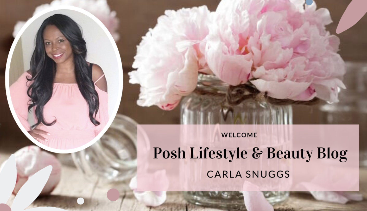 A woman with long dark hair, wearing a pink off-the-shoulder top, smiling. The background features pink peonies in a glass jar and text overlay welcoming visitors to the Posh Lifestyle & Beauty Blog by Carla Snuggs.