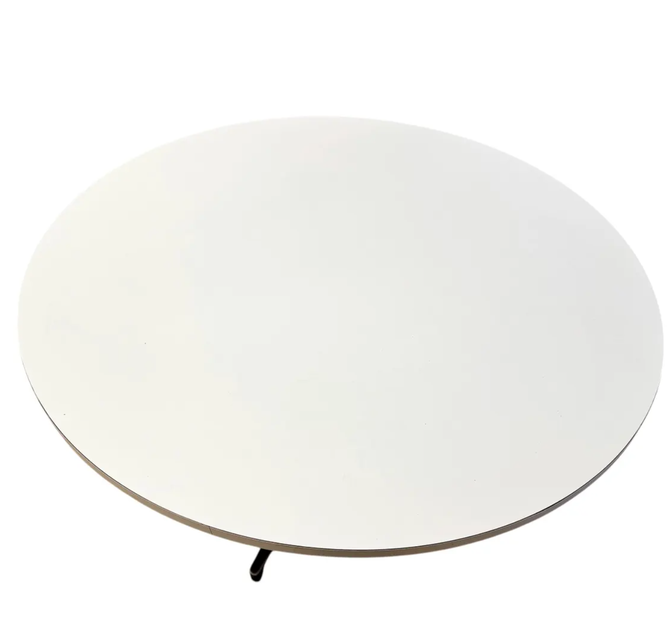 Overhead view of the round white laminate dining table highlighting the smooth surface and clean, minimalist design.