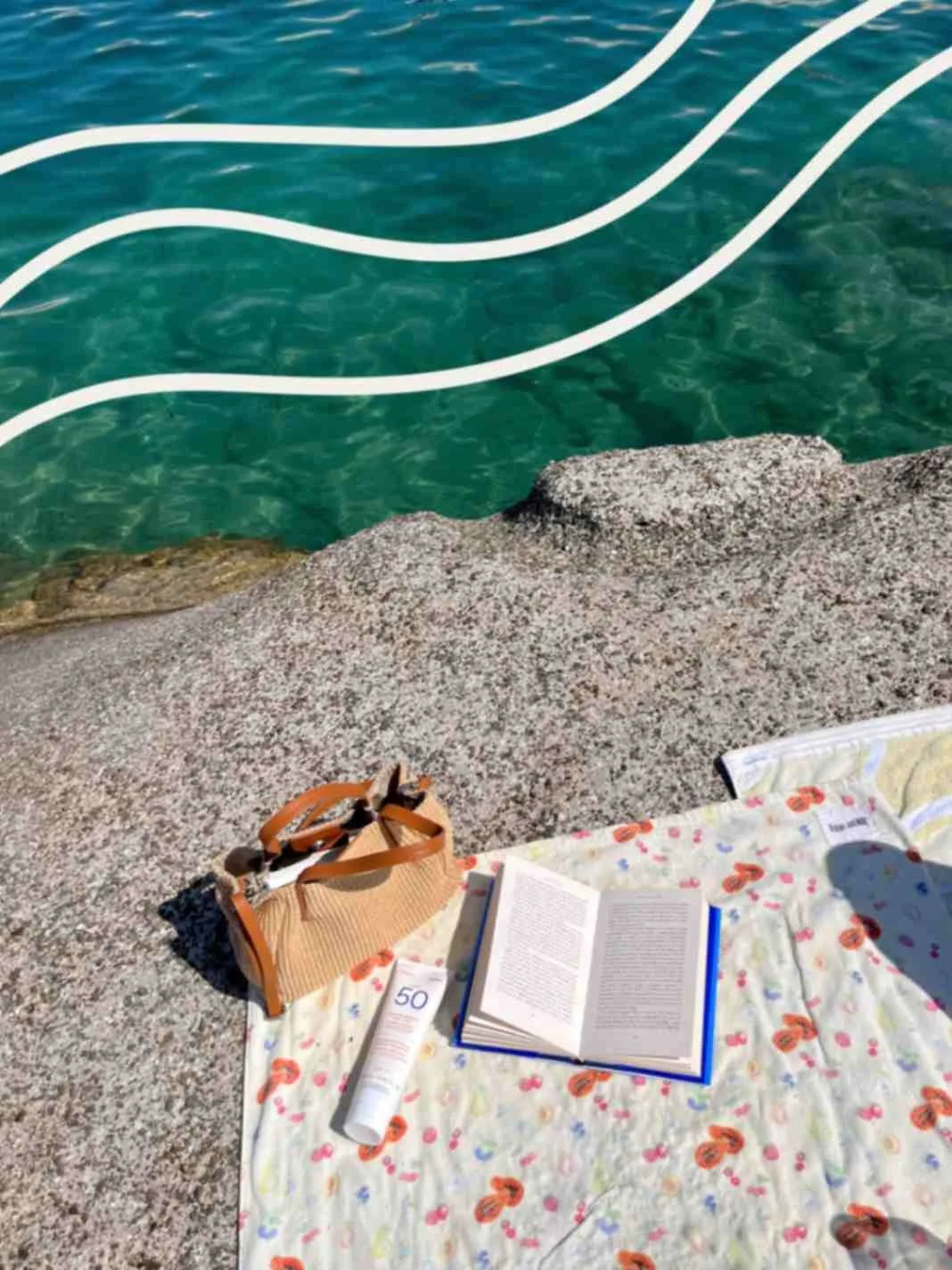A picnic with a book by the sea representing storytelling