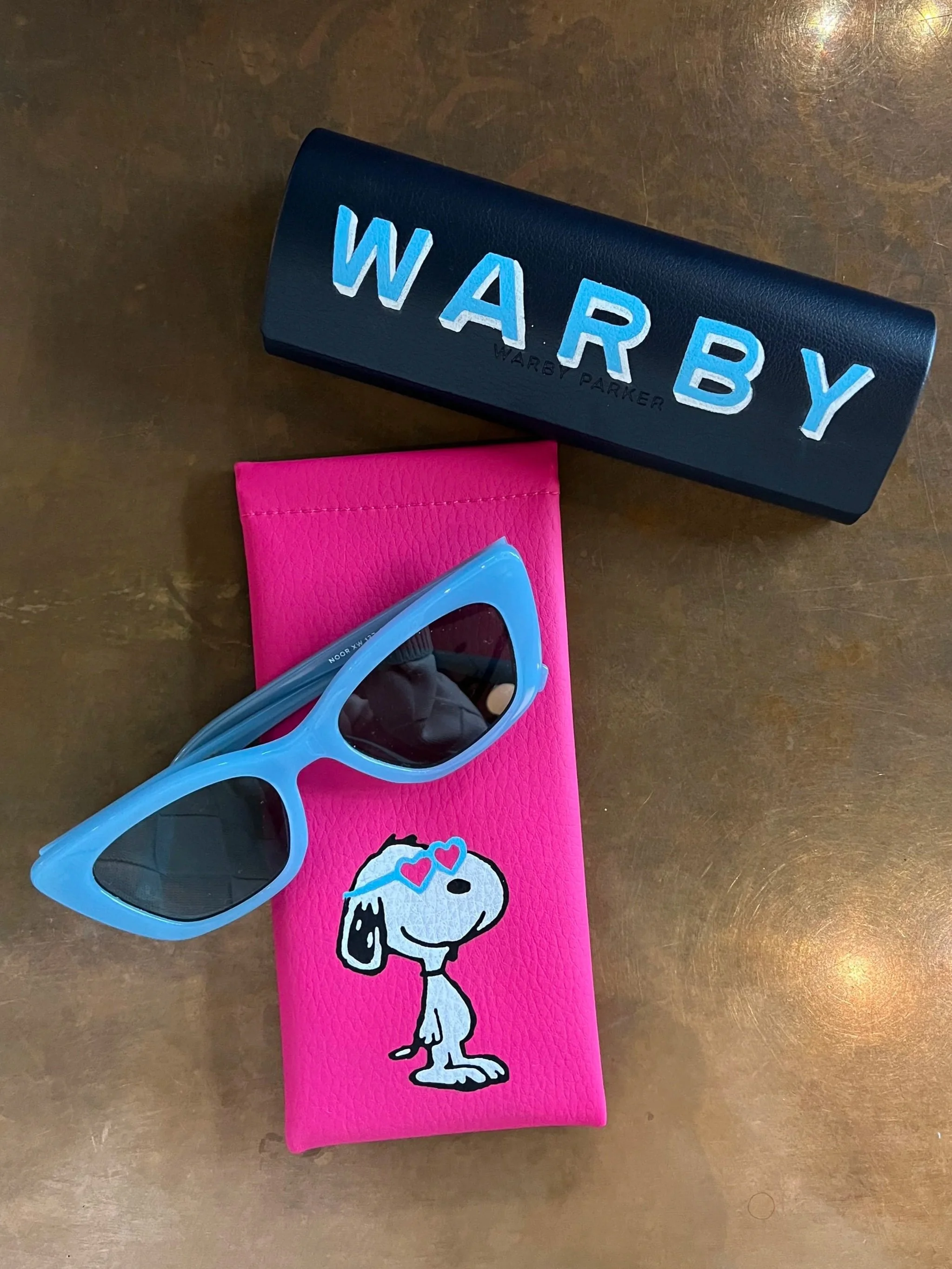 Hand painted glasses cases/pouches with Snoopy and block lettering.