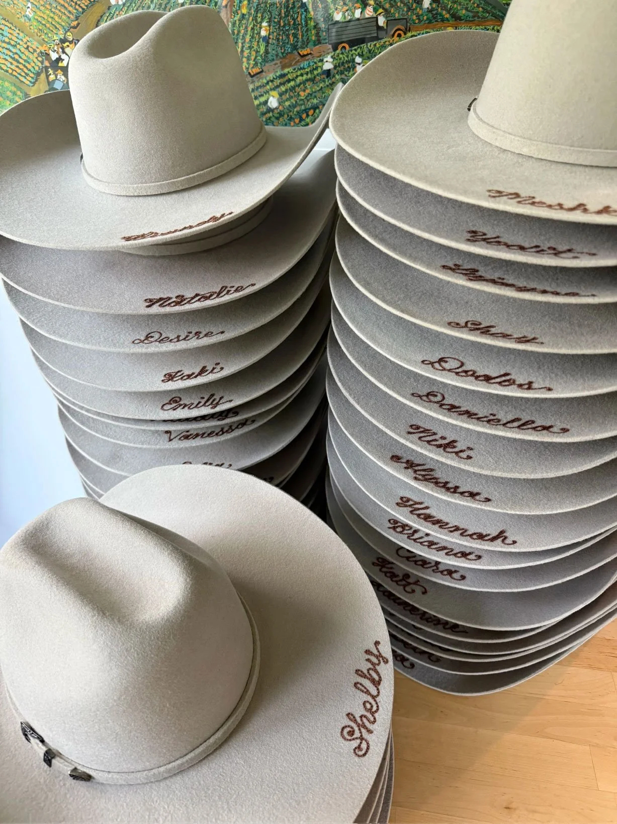 Chainstitched felt cowboy hats. One name chainstitched on eat cowboy hat in brown thread. Perfect for wedding parties, client appreciation, or corporate gifting.