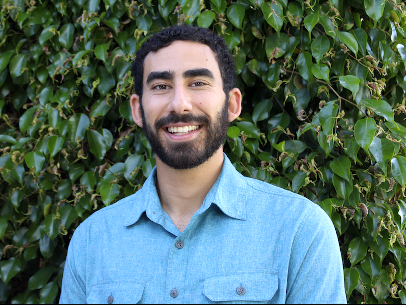 an image of David Ibrahim smiling at the camera