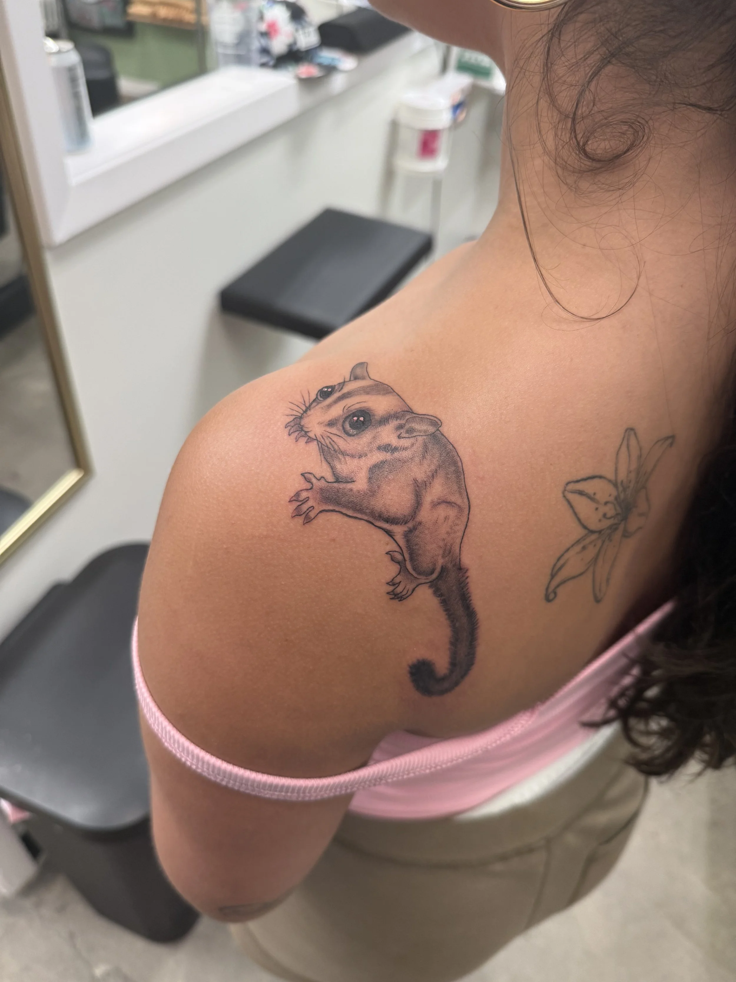 A tattoo of a sugarglider with large eyes on a person's shoulder. Tattoo by Elizabeth Guerrero at Austin Texas Tattoos in 2026