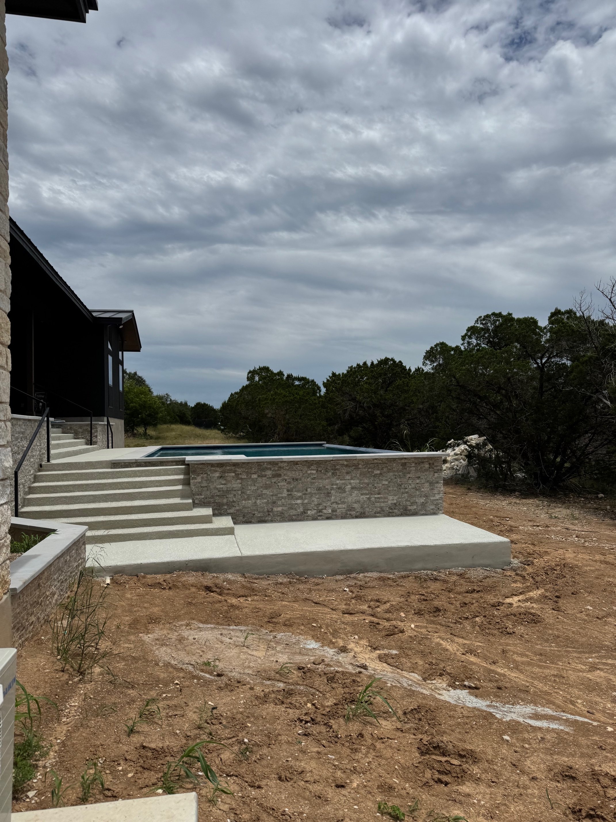 Custom-built modern pool with full-length steps and shallow sun shelf