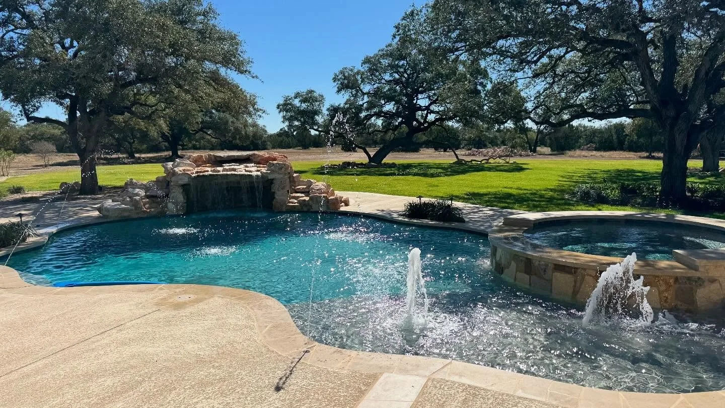 Varsity Pools New Braunfels finished pool with water fountains and cave