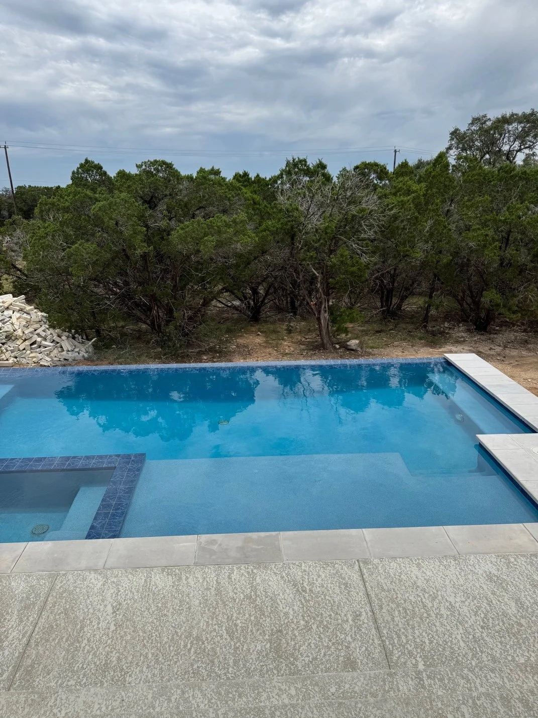 Custom geometric pool with clean lines and minimalist concrete decking