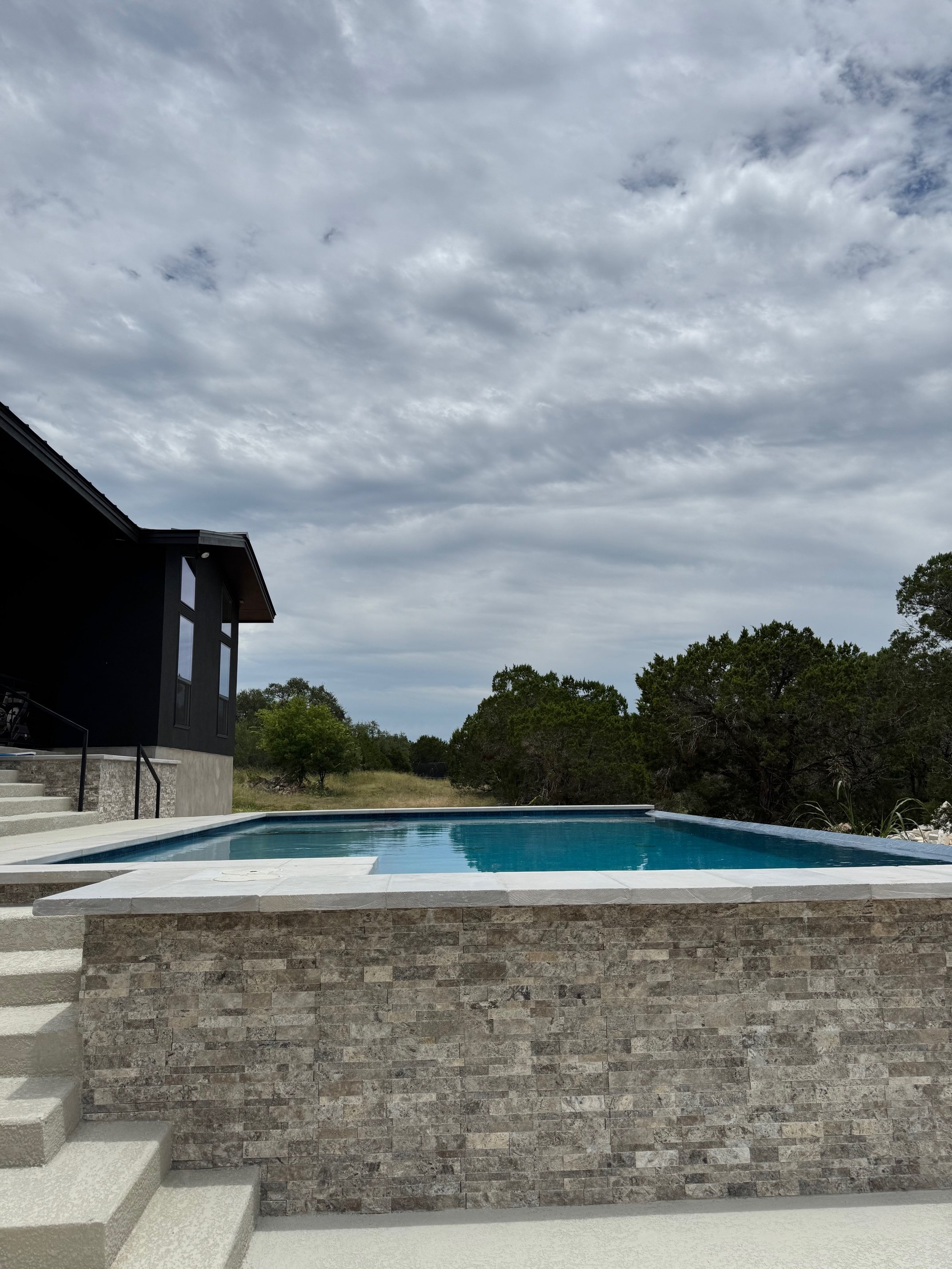 Infinity edge swimming pool with expansive views and refined materials