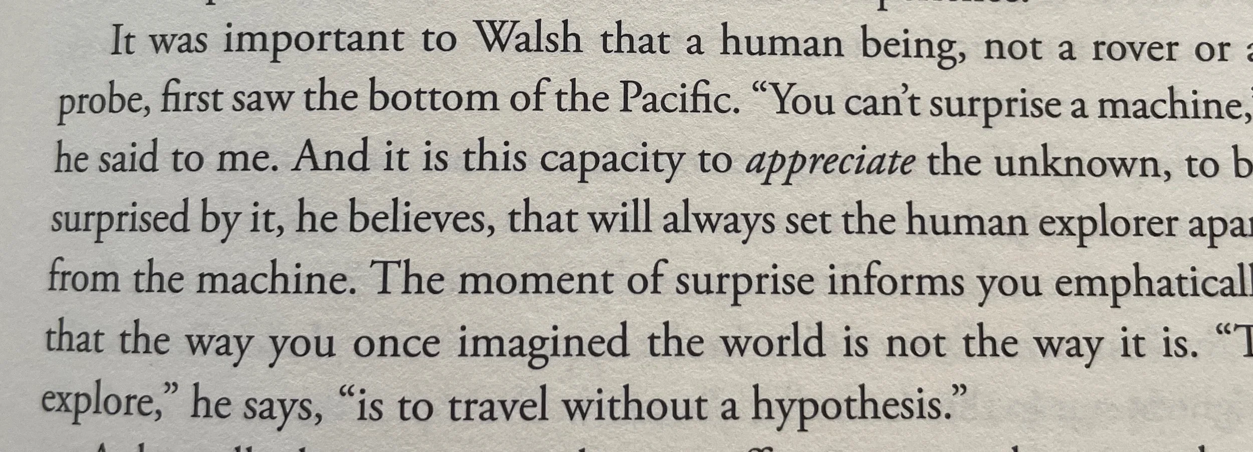 Close-up of a page from a book discussing exploration, machines, and the human experience, highlighting a quote about traveling without a hypothesis.