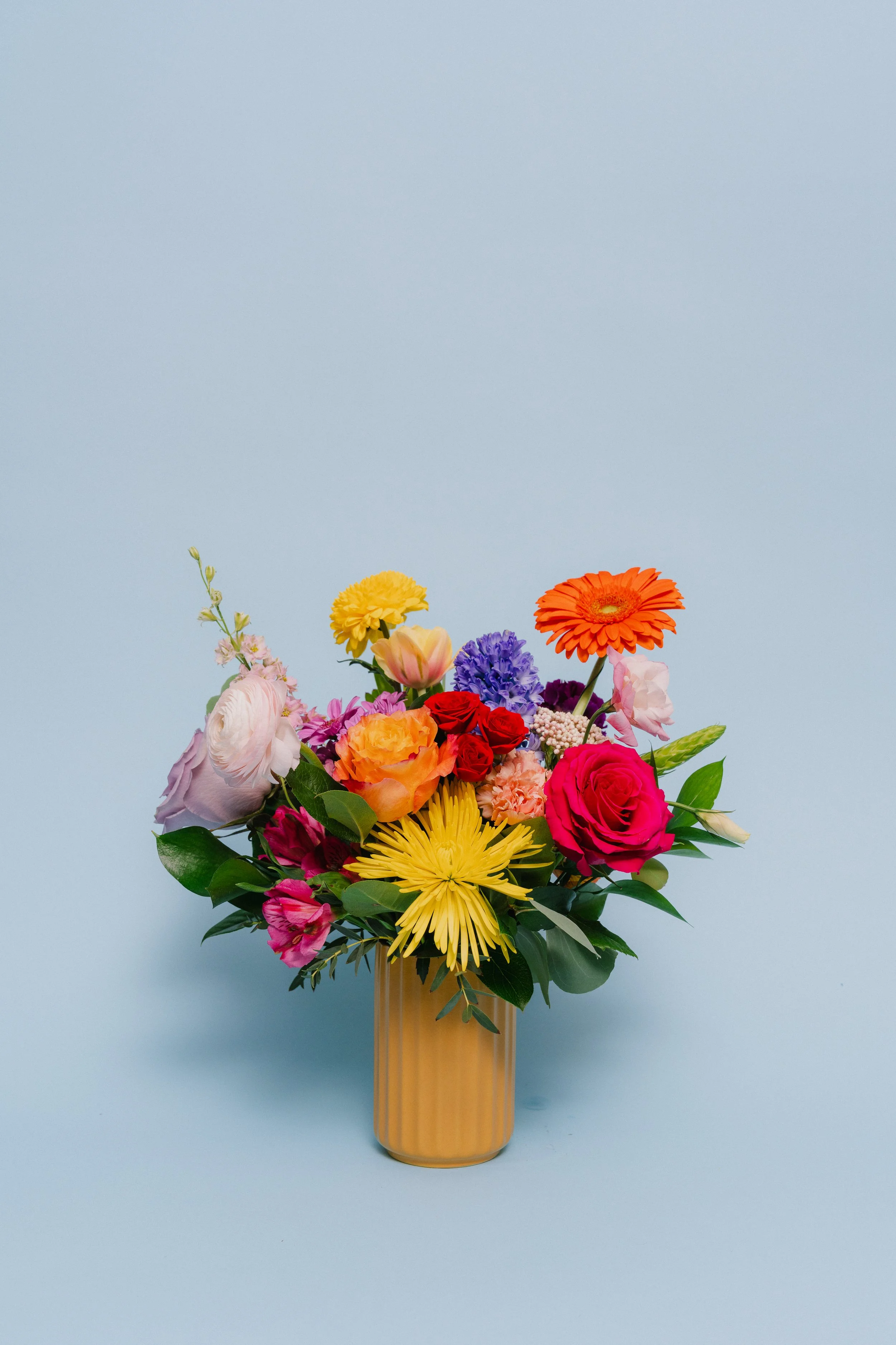 Momma Mia - a small, but awesome bouquet in a ribbed ceramic vase filled with a whimsical colorful mix.  Varieties will vary depending of availability - $99.95