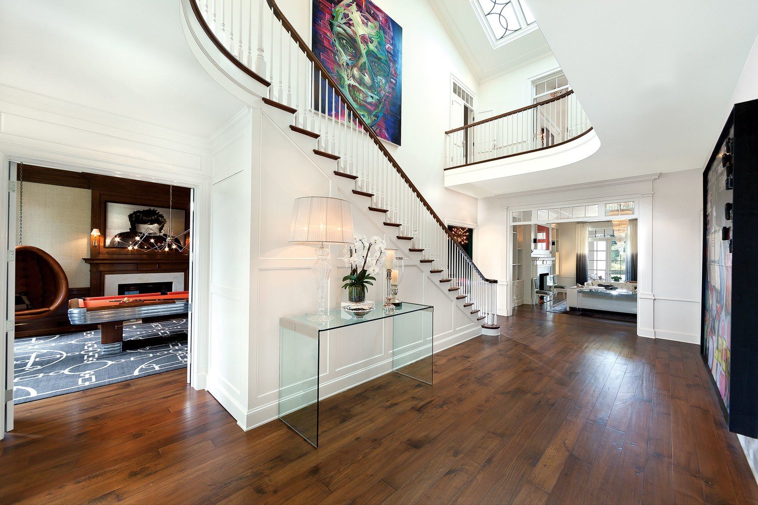 This spacious foyer in Brentwood Park features custom woodwork and a bright entryway.