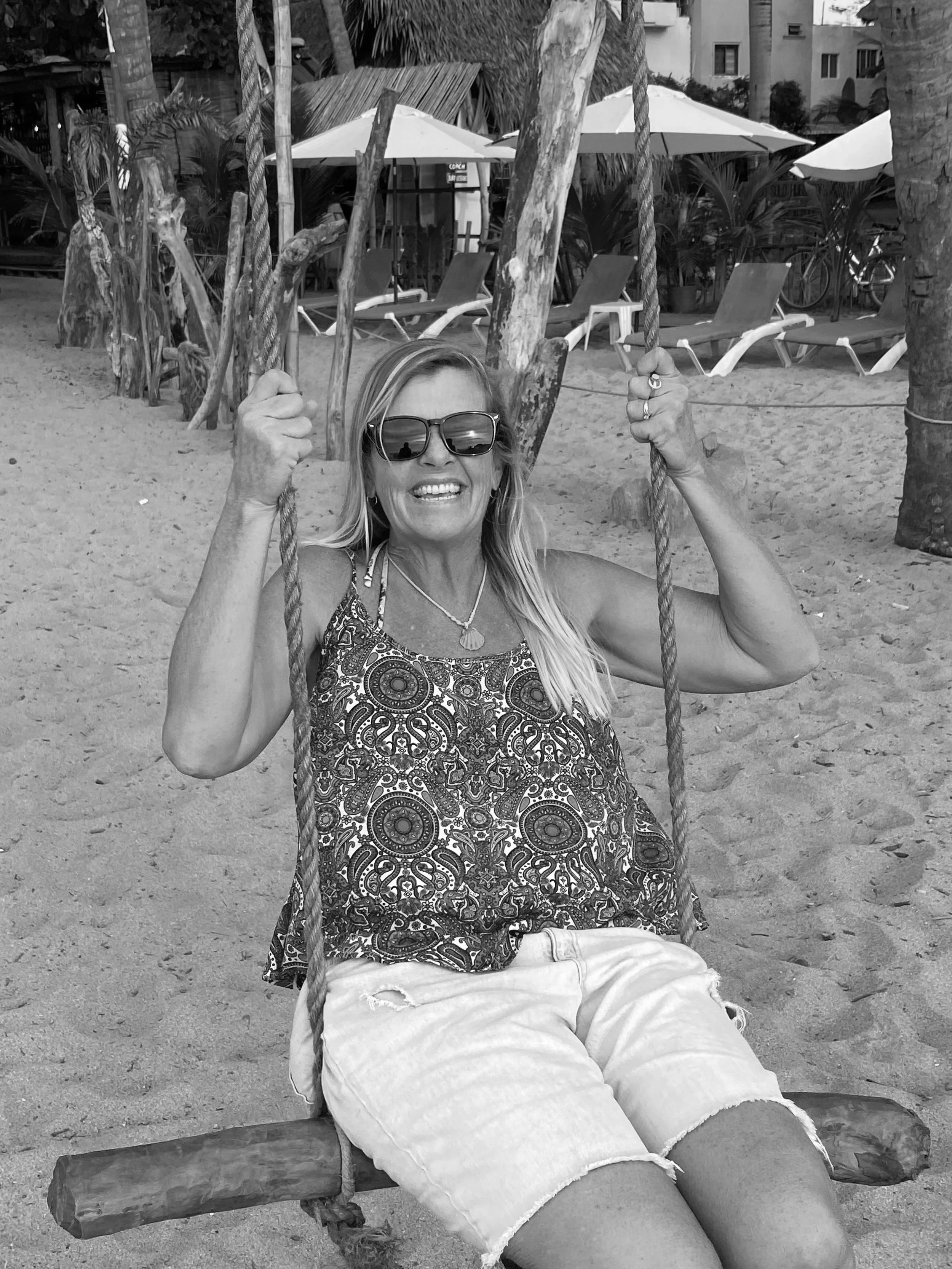Suzy Seymour of Suz The Designer is swinging on a swing in Mexico