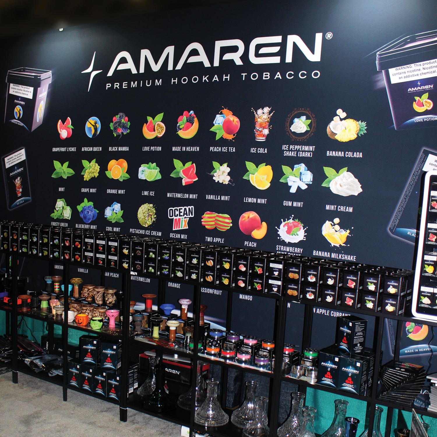 Display of various flavors of Amaren premium hookah tobacco with corresponding packaging and glass hookah equipment.