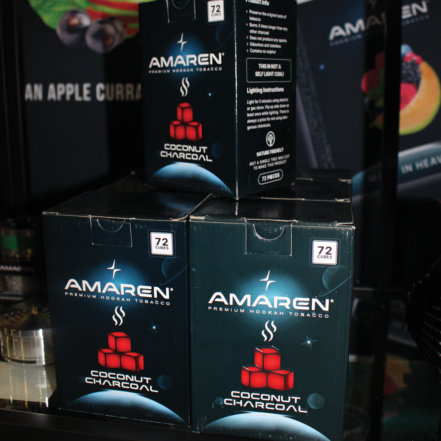 Packages of Amaren coconut charcoal for hookah stacked on a shelf, labeled with 72 cubes per box.