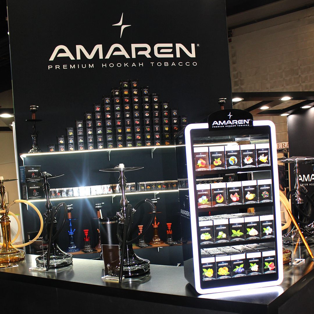 Display booth showcasing Amaren premium hookah tobacco, featuring a variety of hookah setups and a lit display with tobacco flavors.