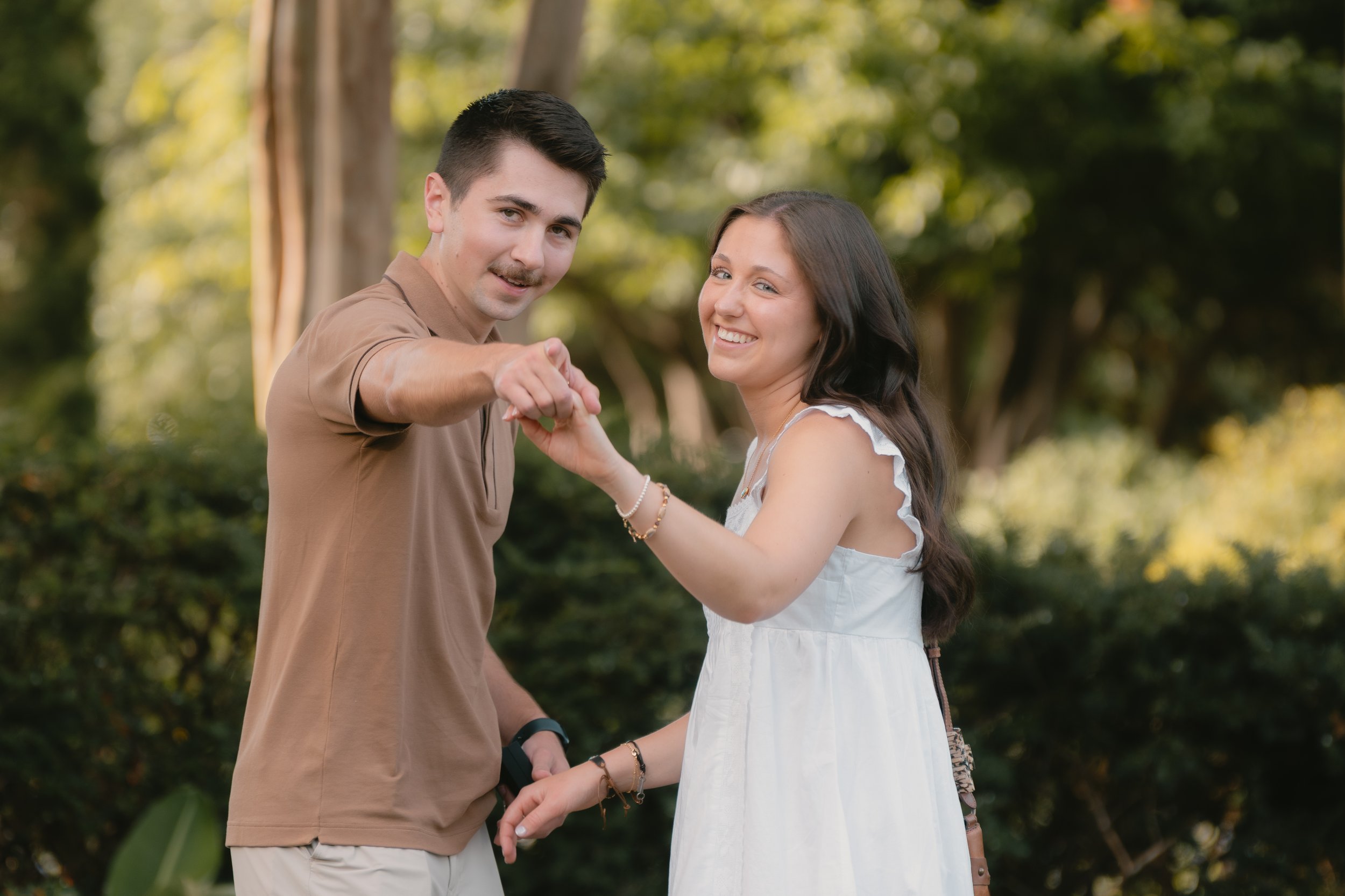 couple pointing at the photographer