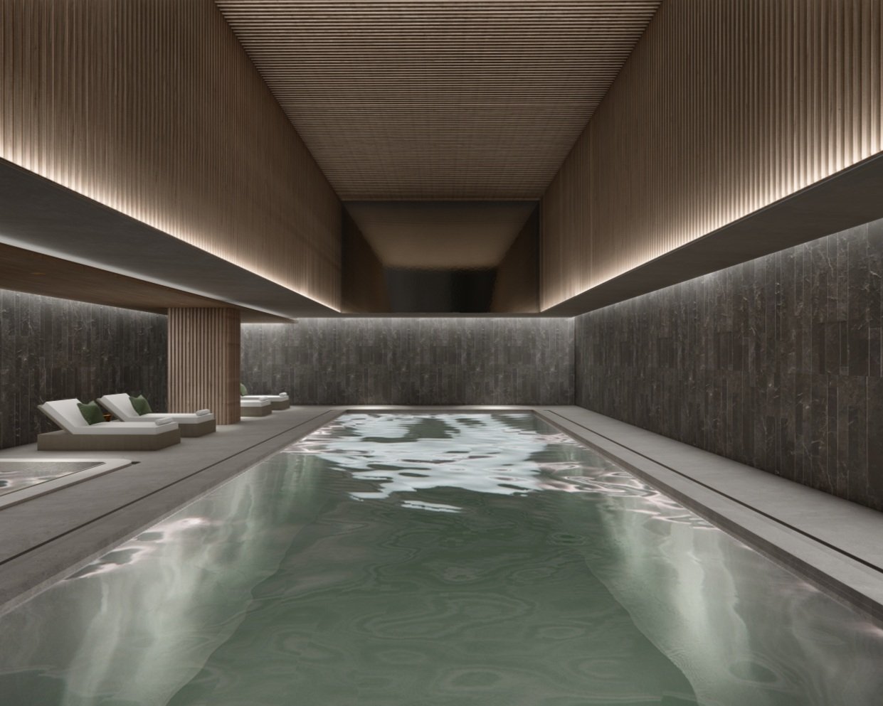Indoor swimming pool with lounge chairs and modern wooden decor.