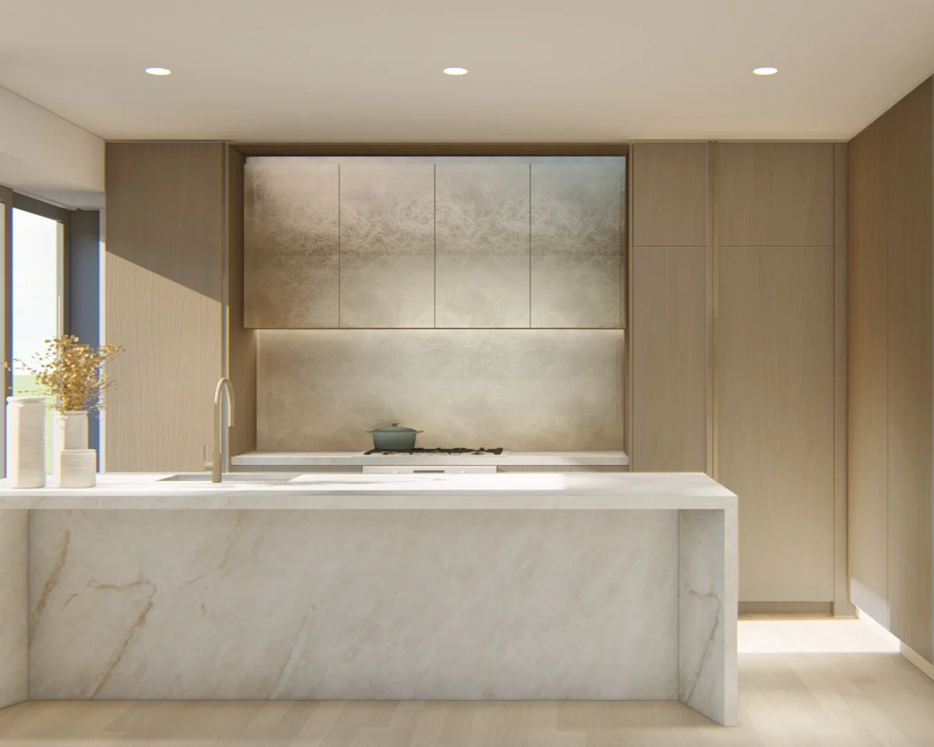Modern kitchen with marble island, beige cabinetry, and built-in stovetop.