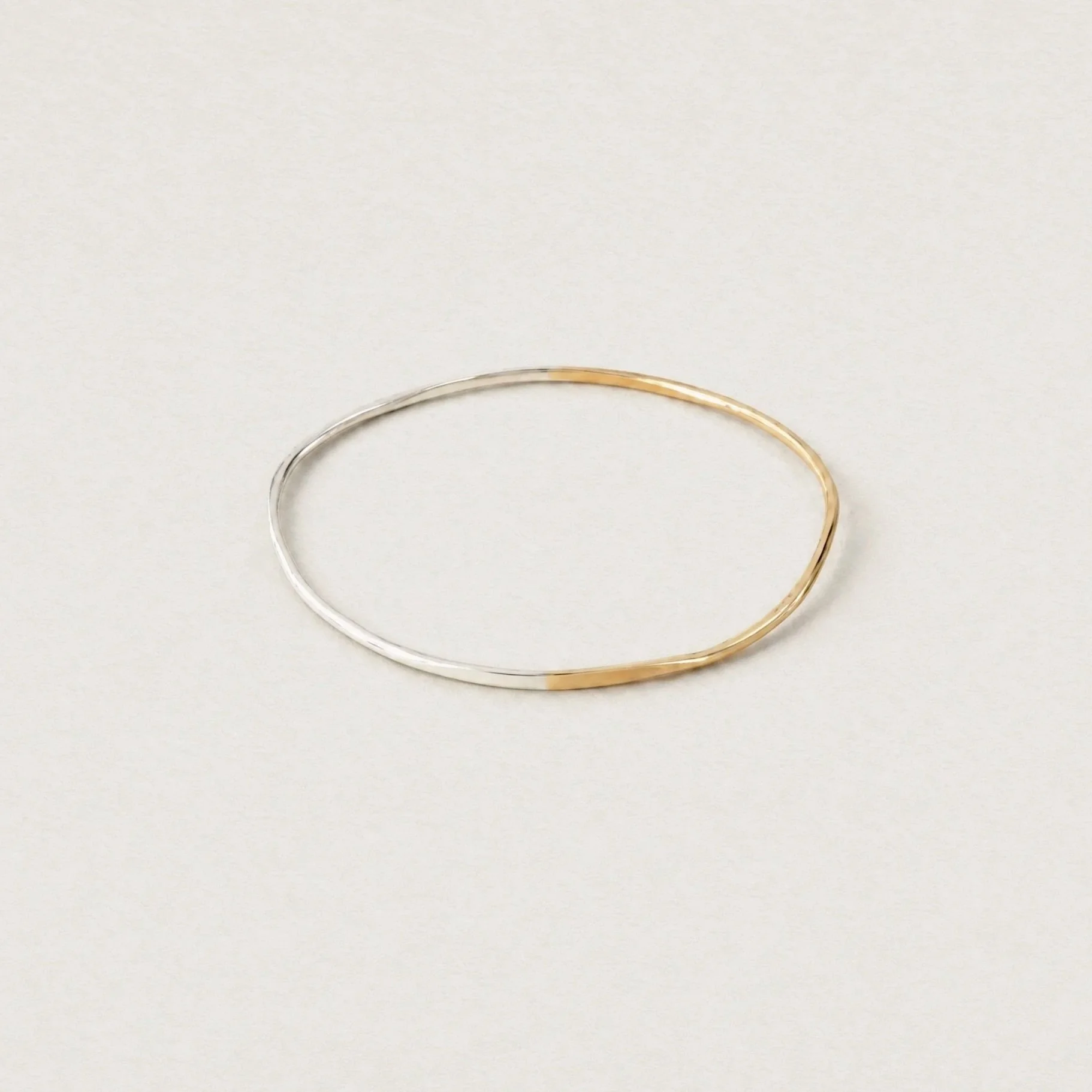silver and gold hammered oval bangle