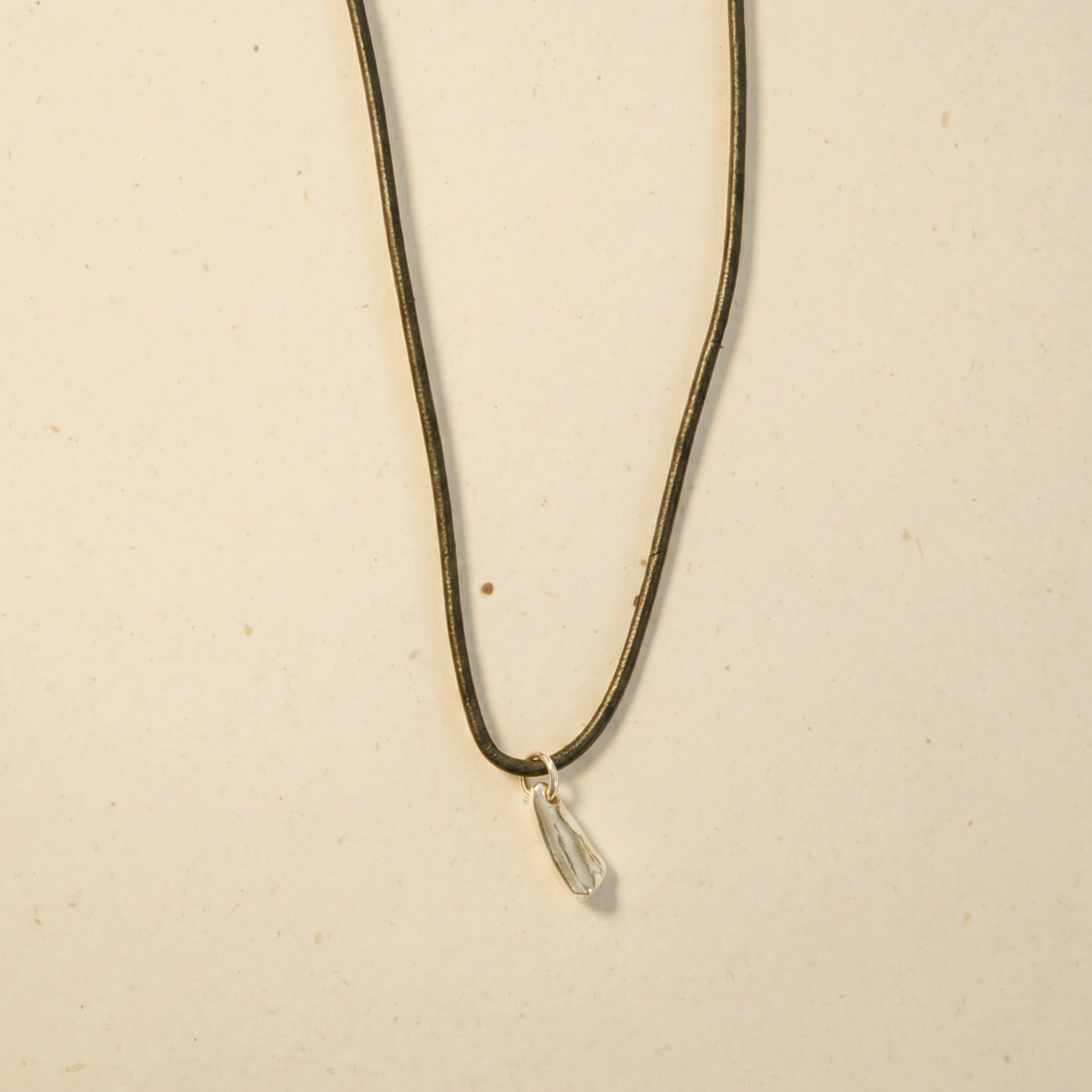 silver lilac flower on leather cord