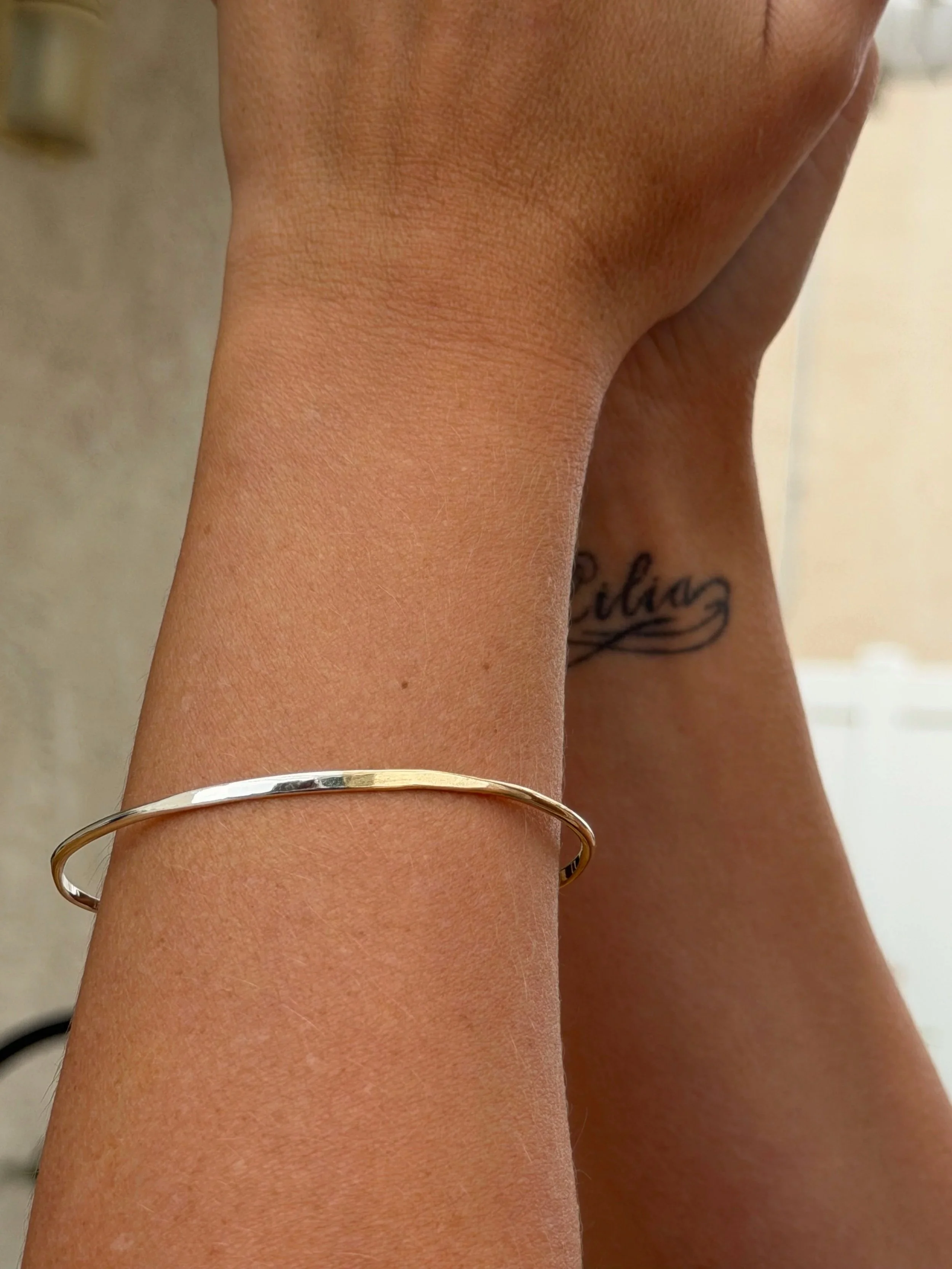 silver and gold hammered oval bangle