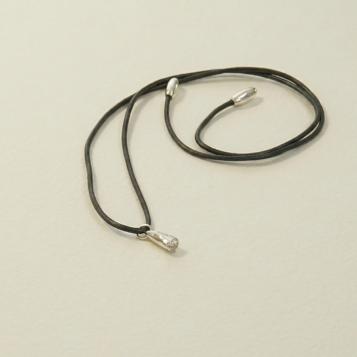 silver lilac flower on leather cord