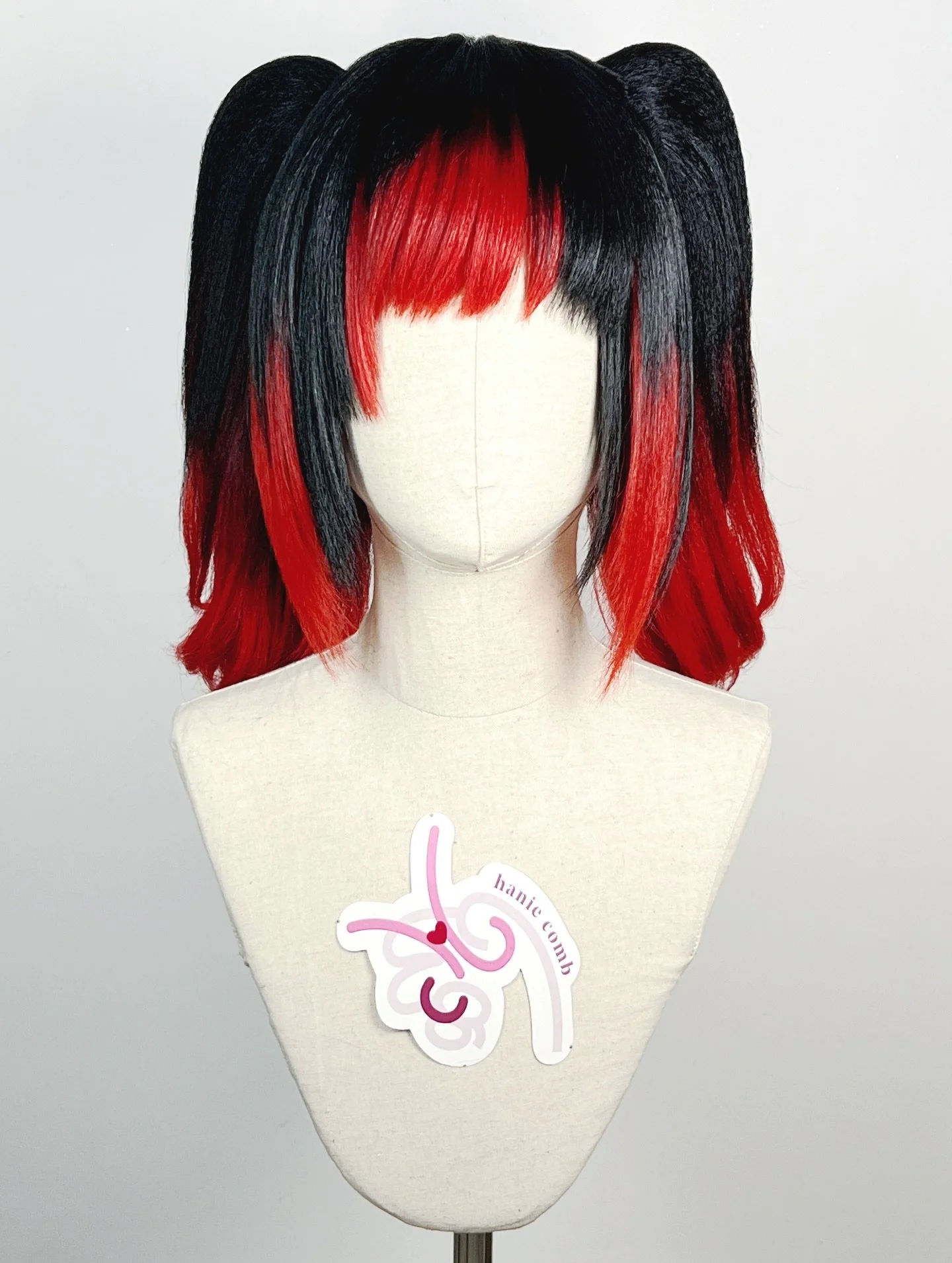 Warrior of Light from FFXIV

Zig zag parting helmet wig then added black wefts over red wefts to create the color transition and highlights similar to the reference
