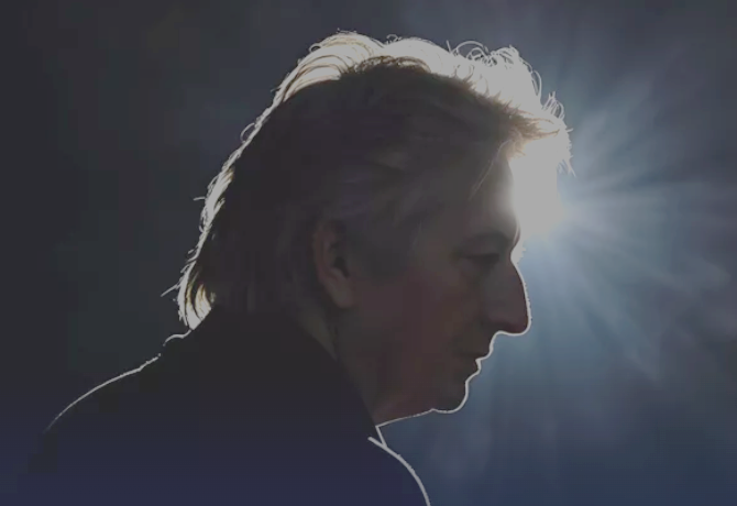 Silhouette of a person with light shining behind their head, creating a halo effect.