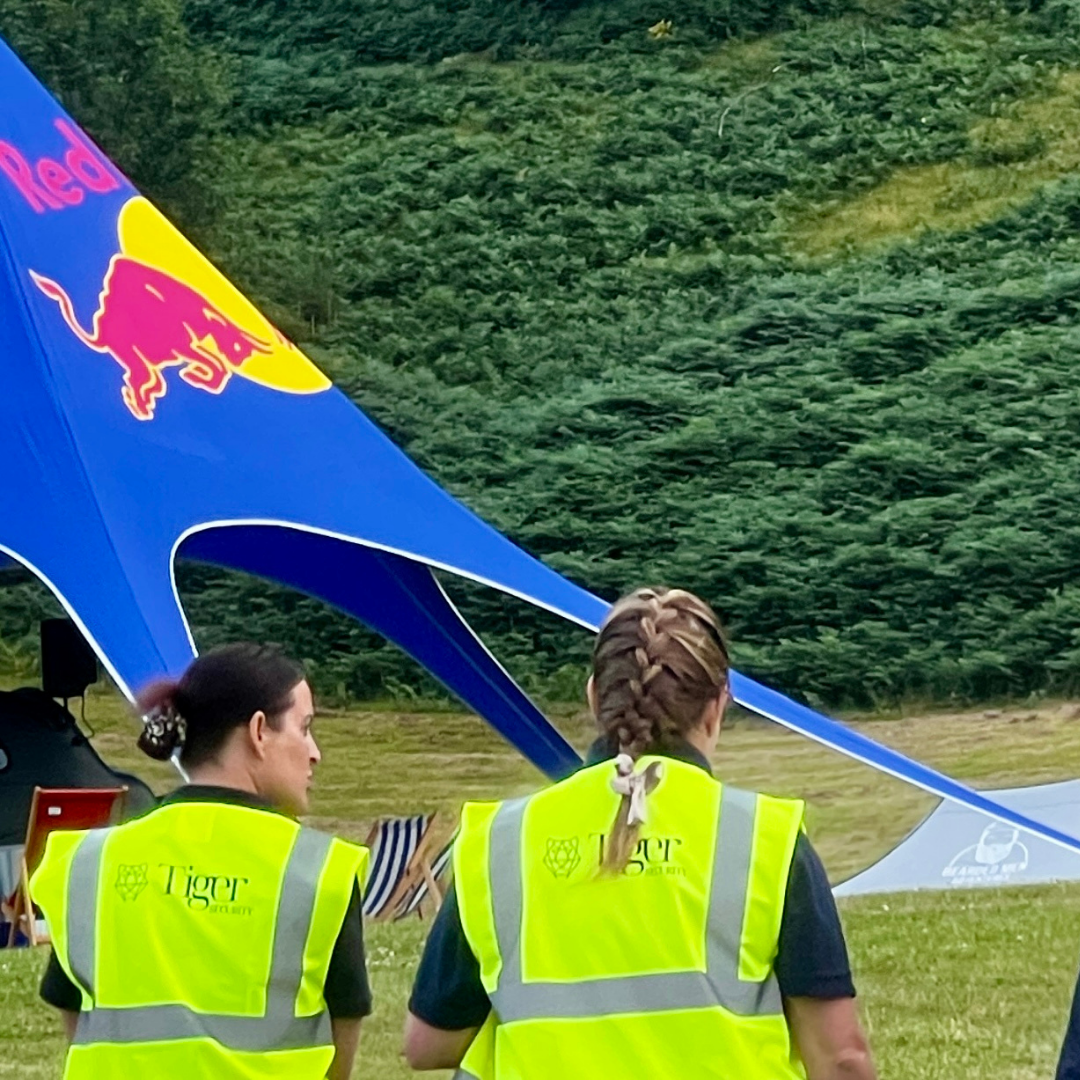 Female security walking across green space at the Camp VC even in Llangollen
