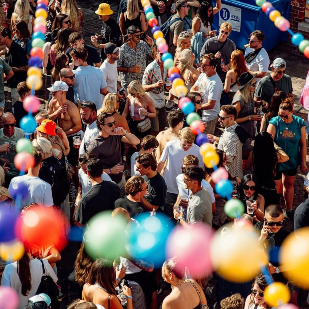 The Castle at Portsmouth where the Victorious festival is held.  Coloured festoon is suspended above party revellers as they dance below