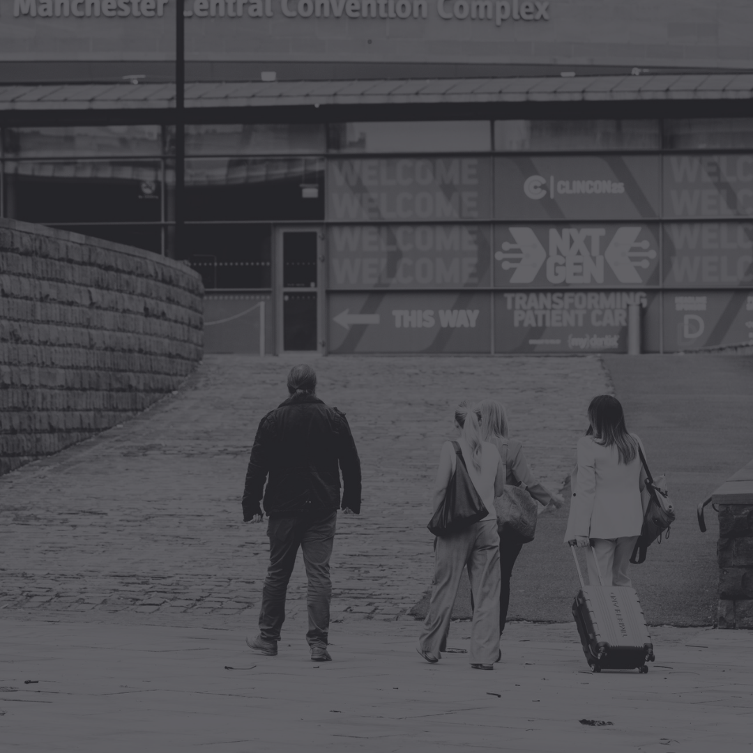 Interior of a modern restaurant with wooden floors, tables set with glasses and cutlery, and stylish hanging light fixtures.