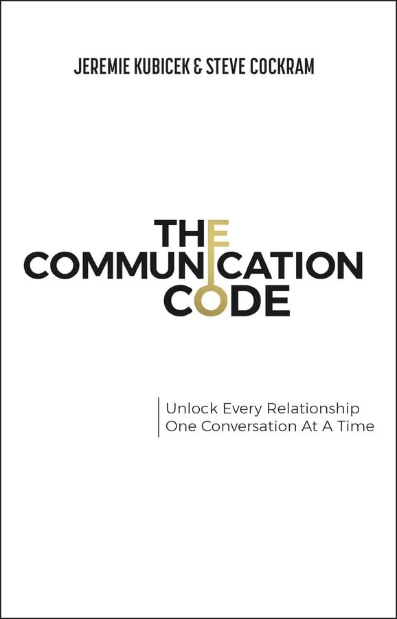 Book cover titled 'The Communication Code' by Jeremie Kubicek and Steve Cockram, featuring a design with the word 'E' stylized as a question mark connecting the words.