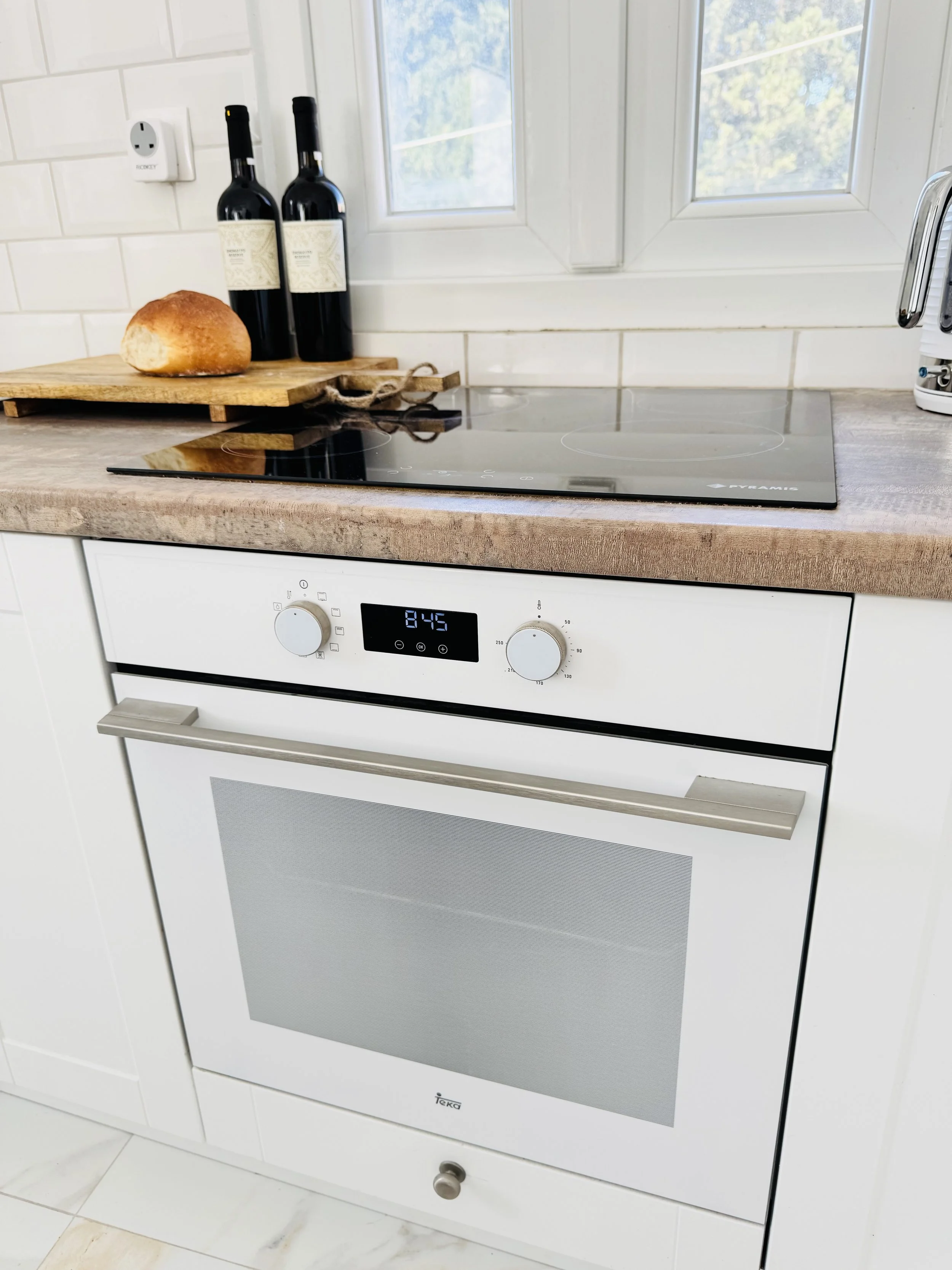 The Kitchen at The Yellow House Villa in Kassiopi includes Neff appliances electric hob and convection oven.