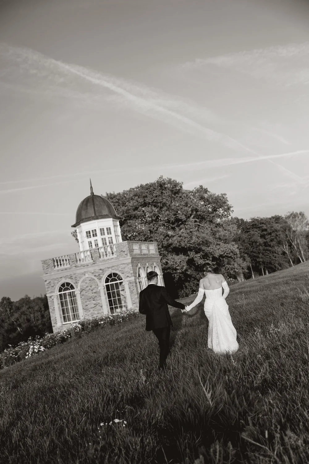 Bride and groom walking through confetti at Field Place worthing